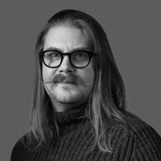Long haired male
                                  with glasses and manicured moustache
